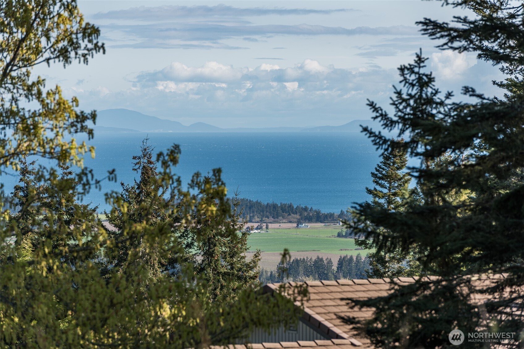 999 Ravens Ridge Road Sequim, WA 98382 - Photo 15 of 40 a view of a lake with a yard