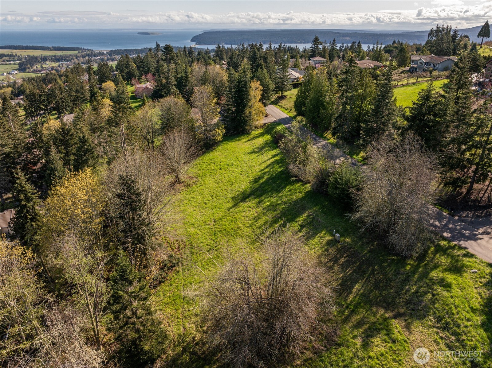 999 Ravens Ridge Road Sequim, WA 98382 - Photo 21 of 40 a view of a lake with houses