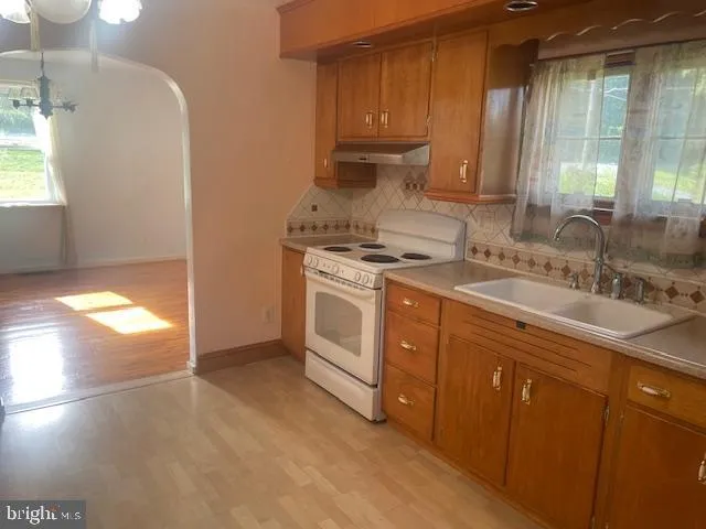 a kitchen with a sink stove and cabinets