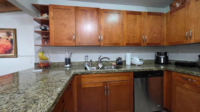 a kitchen with stainless steel appliances granite countertop a refrigerator stove and microwave