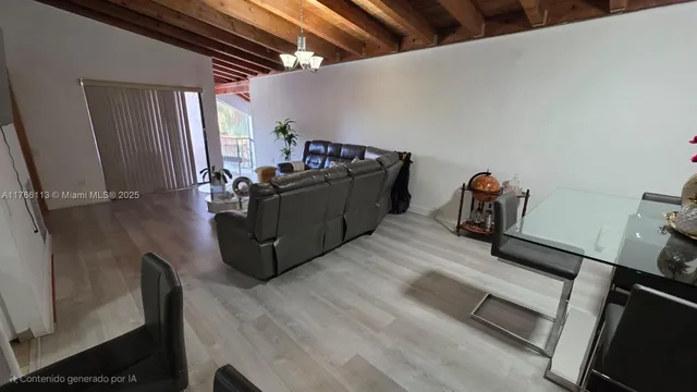 a living room with furniture and a mirror