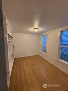 1414 East Fir Street Seattle, WA 98122 - Photo 11 of 30 wooden floor in an empty room with a window