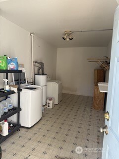 1414 East Fir Street Seattle, WA 98122 - Photo 18 of 30 a room with a washing machine and a wooden floor