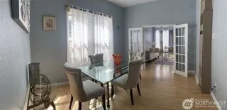 a dining room with furniture and wooden floor
