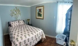 a bedroom with a bed and a painting on the wall