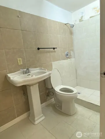 a white toilet sitting next to a bathroom sink