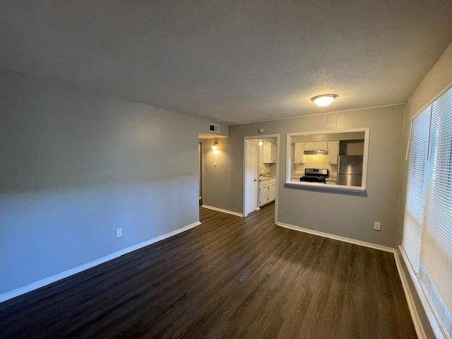 605 Patterson Street, Unit 7 Memphis, TN 38111 - Photo 2 of 10 a view of an empty room with window and wooden floor