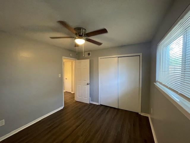 605 Patterson Street, Unit 7 Memphis, TN 38111 - Photo 9 of 10 an empty room with wooden floor chandelier fan and windows