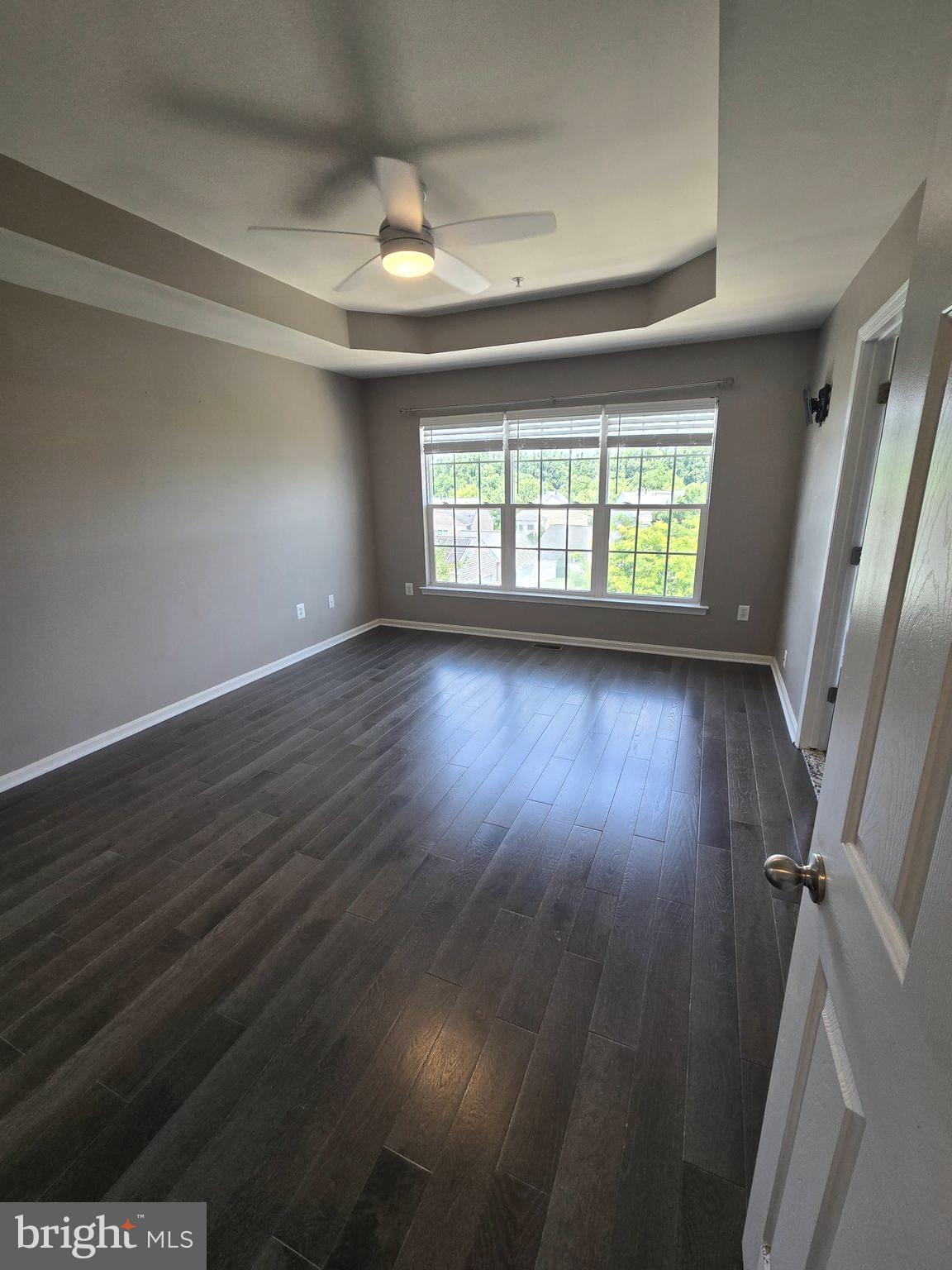 11847 Skylark Road Clarksburg, MD 20871 - Photo 25 of 46 a view of an empty room with wooden floor and a window