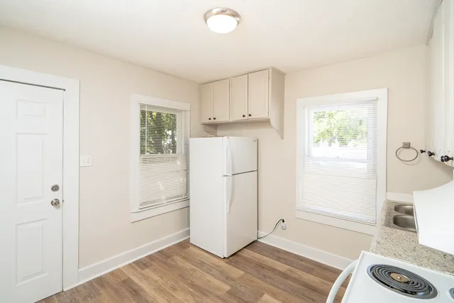 a view of kitchen with furniture and wooden floor