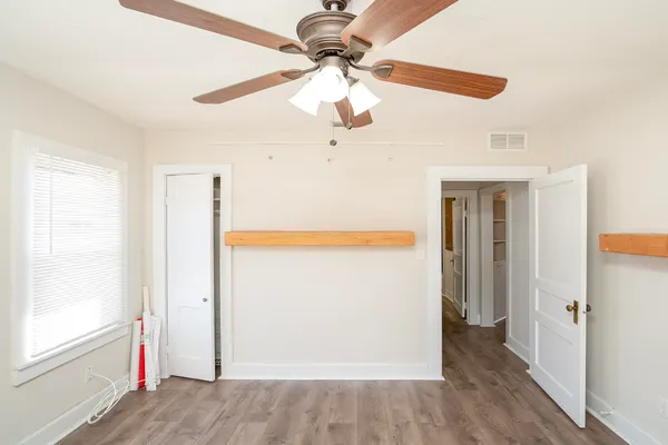 a view of a room with wooden floor