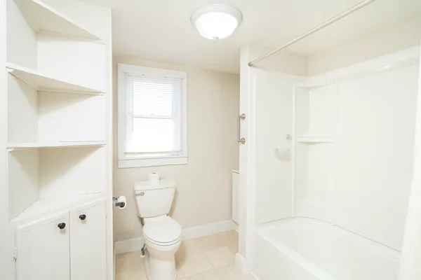 a bathroom with a toilet and a bathtub