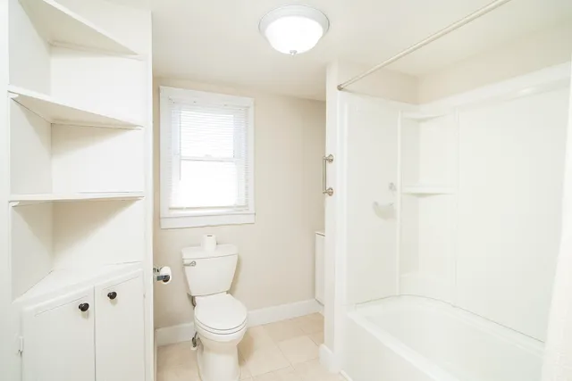 a bathroom with a toilet and a bathtub