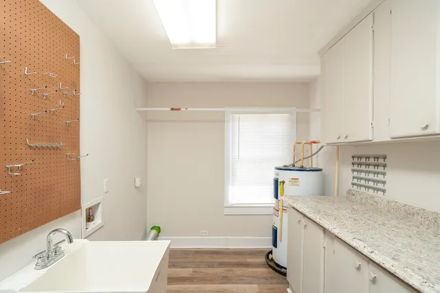 a kitchen with granite countertop a sink and a stove top oven