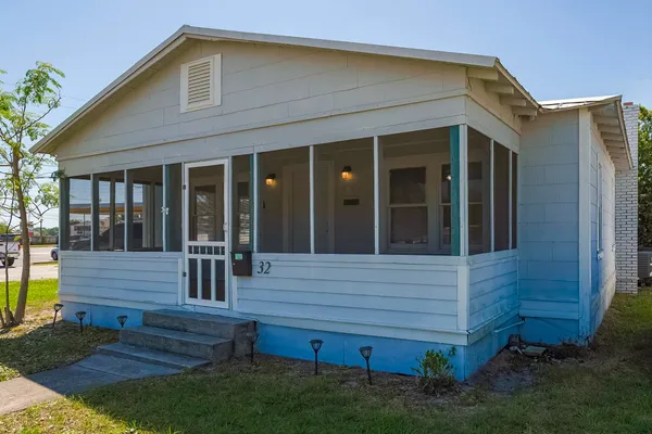 a view of house with wooden door and outdoor seating