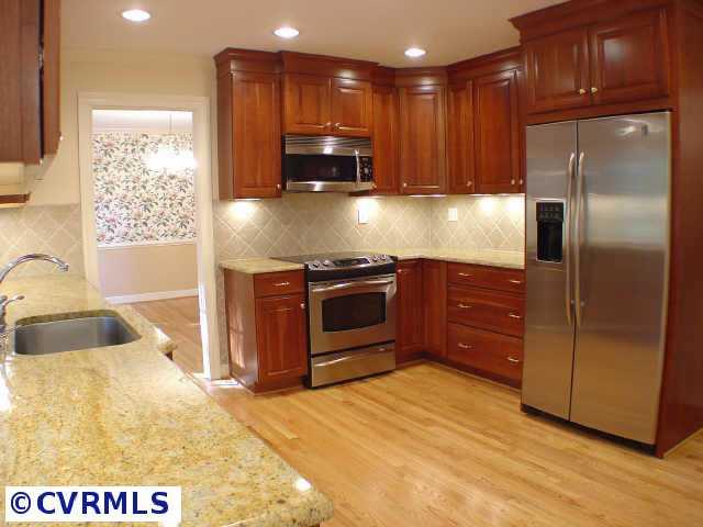14211 Newgate Road Midlothian, VA 23113 - Photo 3 of 10 a kitchen with stainless steel appliances granite countertop a sink a stove and a refrigerator with wooden floor