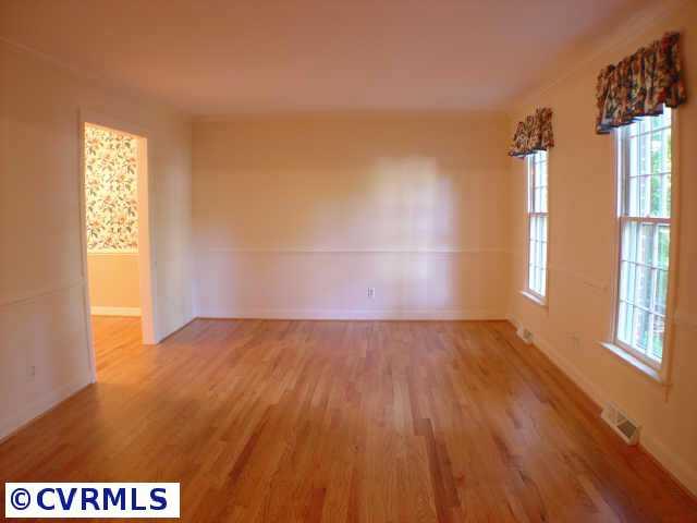 14211 Newgate Road Midlothian, VA 23113 - Photo 8 of 10 an empty room with wooden floor and windows