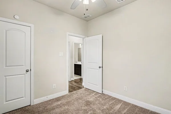 an empty room with kitchen view