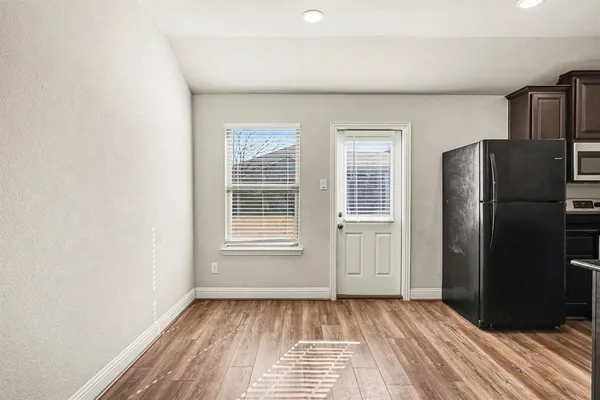 a view of a livingroom with wooden floor and a window