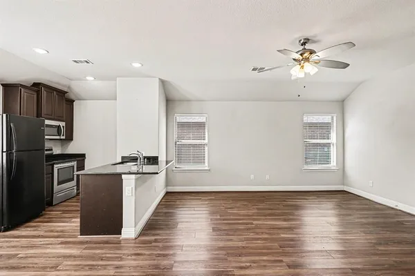 a view of a kitchen with a stove cabinets and wooden floor