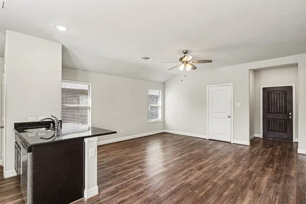 a view of a livingroom with a dishwasher cabinets and wooden floor