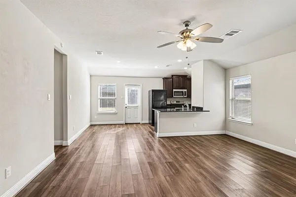 a view of a kitchen with microwave and furniture