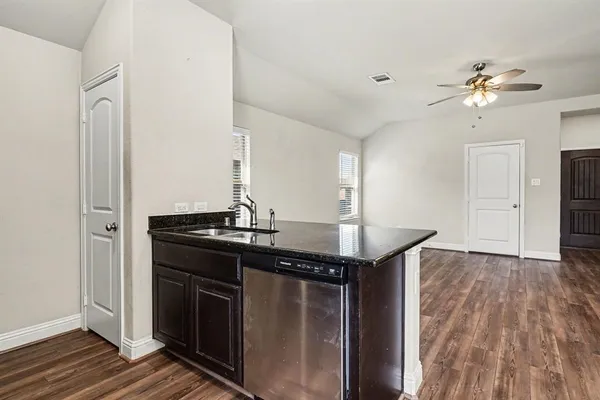 a kitchen with a sink and refrigerator