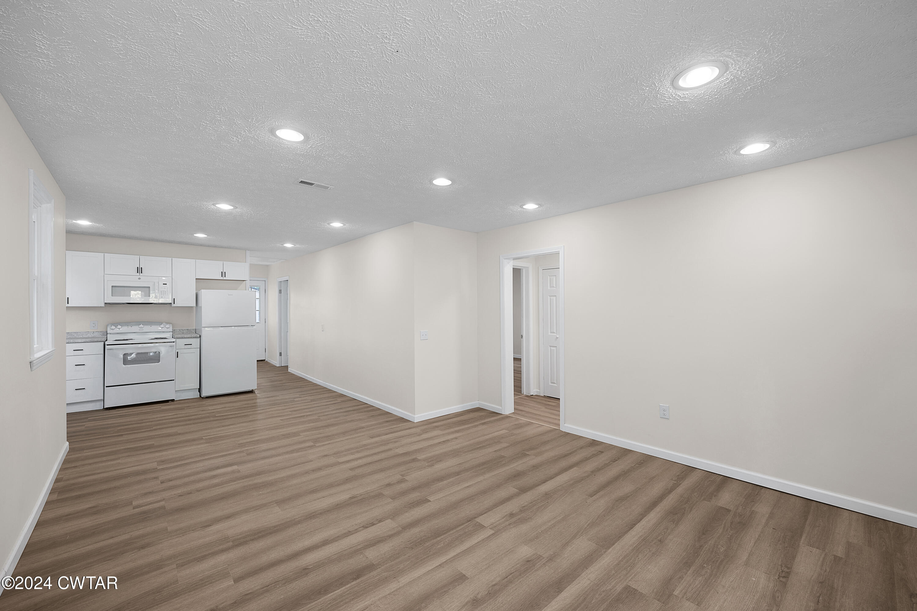 309 West Knox Street Rutherford, TN 38369 - Photo 4 of 16 a view of an empty room with wooden floor