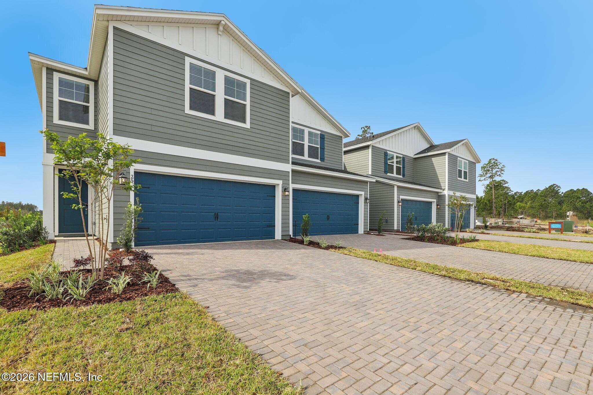 25 Rangeline Drive St. Augustine, FL 32092 - Photo 2 of 43 a front view of a house with a yard and garage