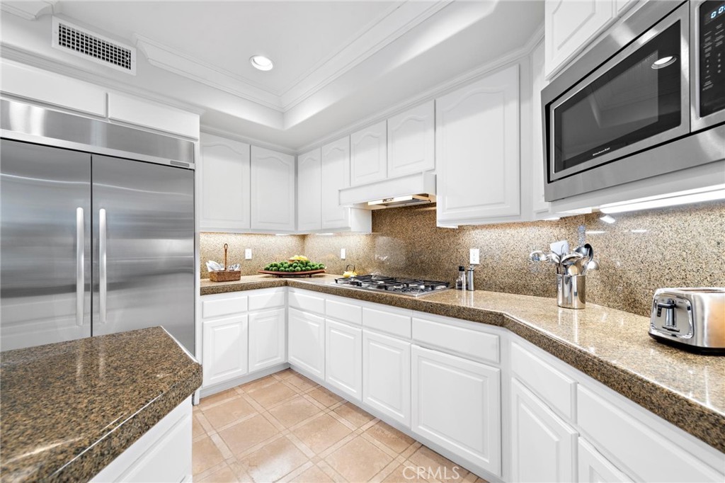 1 Meryton Irvine, CA 92603 - Photo 15 of 40 a kitchen with granite countertop a sink and stainless steel appliances