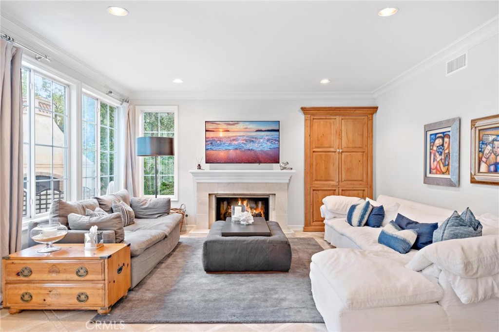 1 Meryton Irvine, CA 92603 - Photo 19 of 40 a living room with furniture fireplace and a large window
