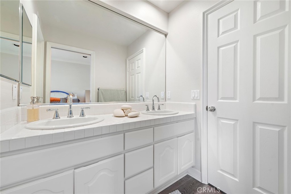 1 Meryton Irvine, CA 92603 - Photo 30 of 40 a bathroom with a double vanity sink and a mirror