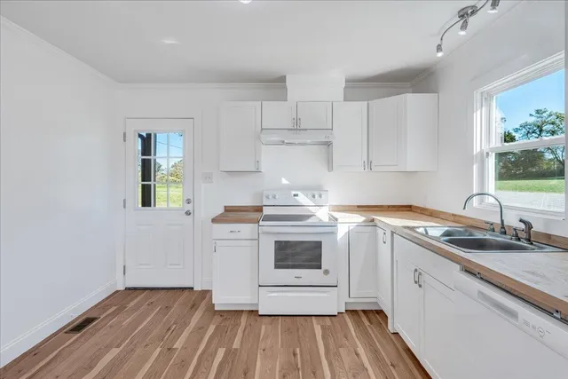 a bathroom with a sink toilet and painting on the wall