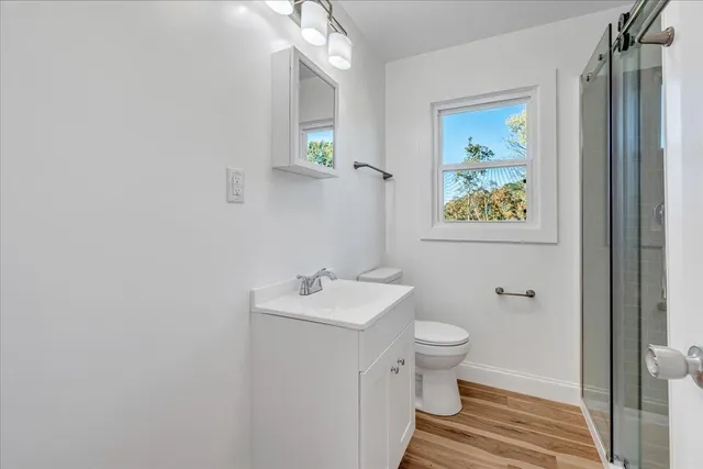 a spacious bathroom with a double vanity sink a mirror and a bathtub