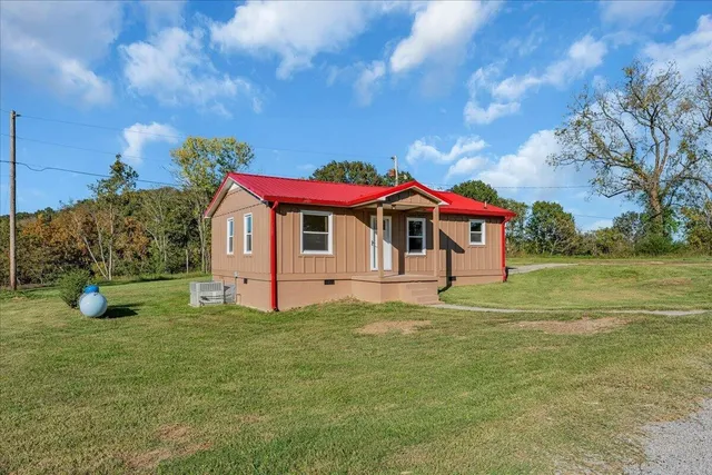 a view of a house with a yard porch and sitting area