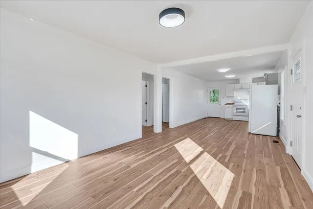 a view of a room with wooden floor