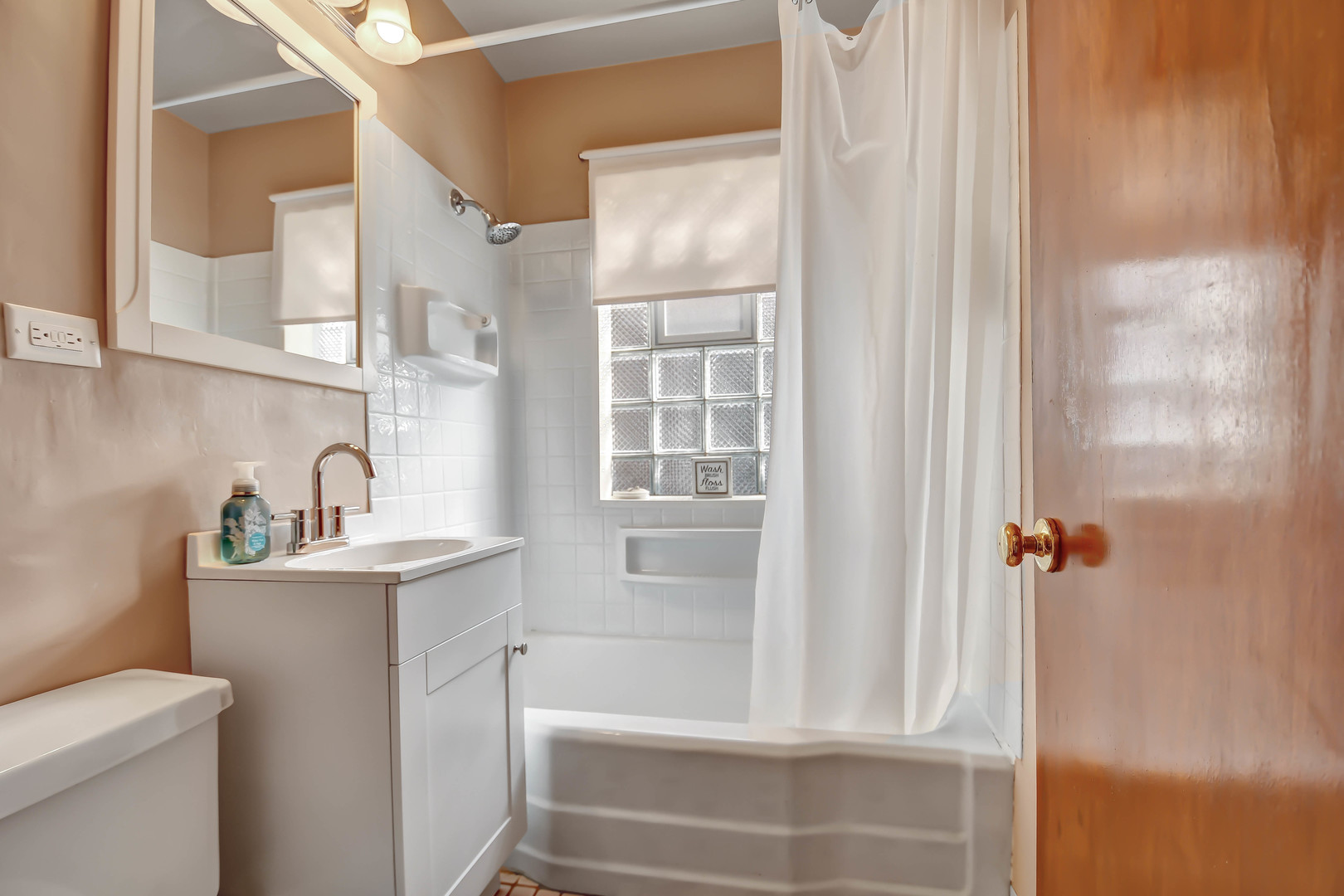 9041 South East End Avenue Chicago, IL 60617 - Photo 11 of 18 a bathroom with a sink a toilet and shower