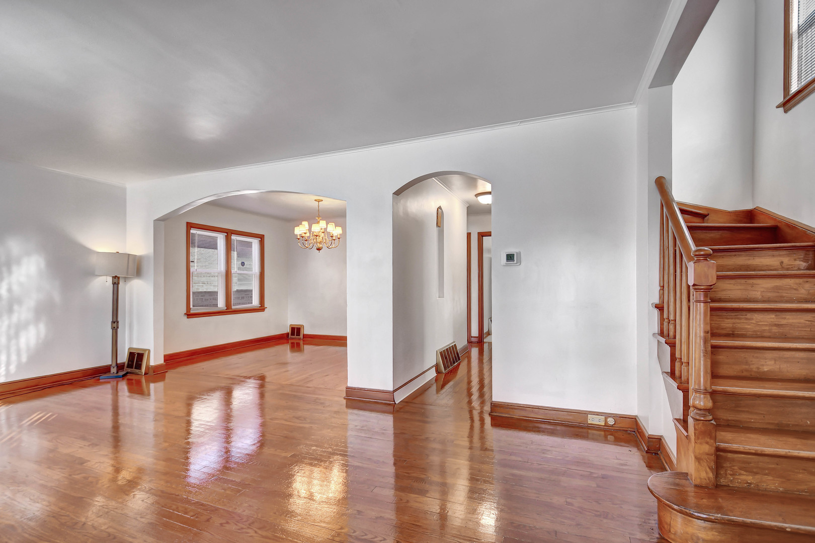 9041 South East End Avenue Chicago, IL 60617 - Photo 2 of 18 a view of a living room and hallway with wooden floor