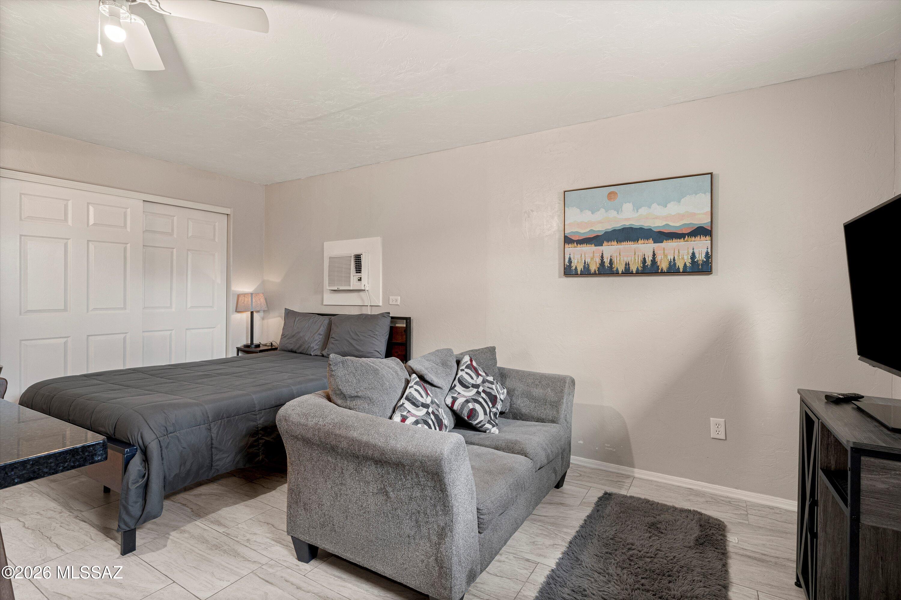 2841 North Richey Boulevard Tucson, AZ 85716 - Photo 28 of 30 a living room with furniture and a flat screen tv