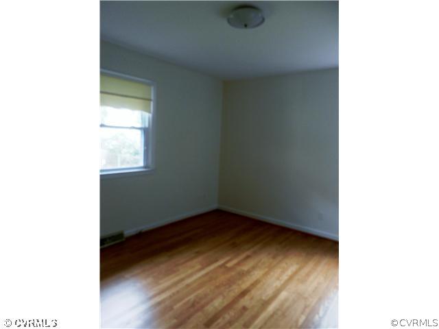 1312 Covington Road Colonial Heights, VA 23834 - Photo 14 of 24 a view of an empty room with wooden floor