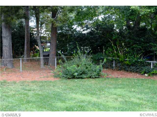 1312 Covington Road Colonial Heights, VA 23834 - Photo 4 of 24 a backyard of a house with lots of green space and garden view