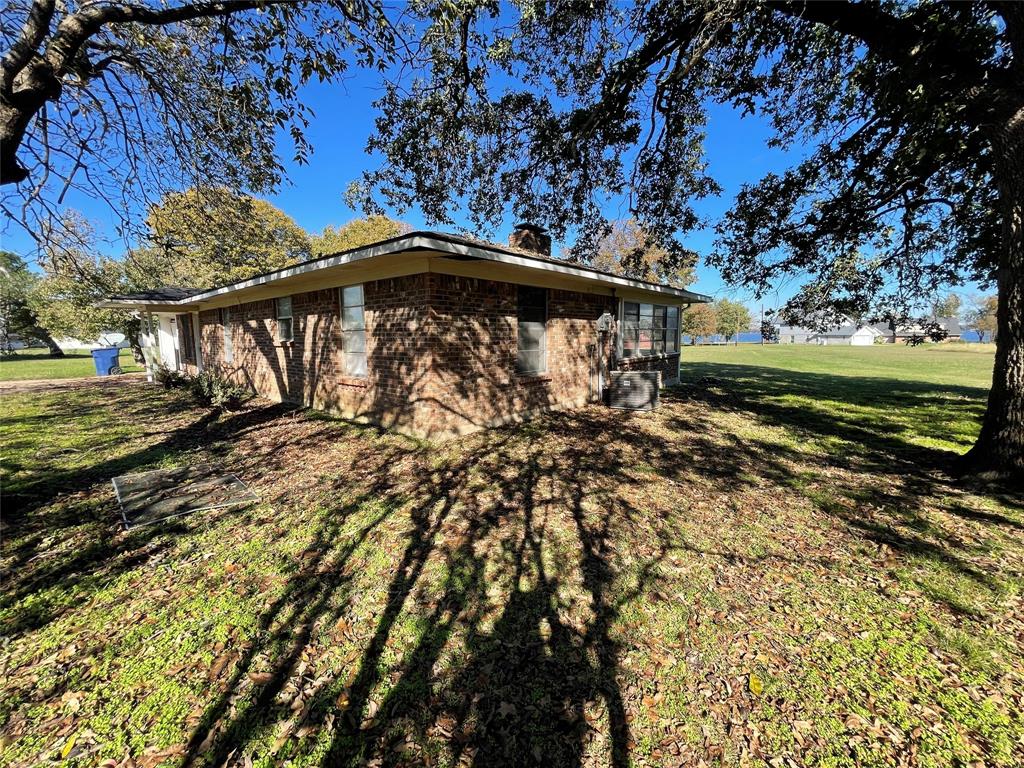 202 Spur Ranch Road Trinidad, TX 75163 - Photo 2 of 20 a view of a yard with wooden fence