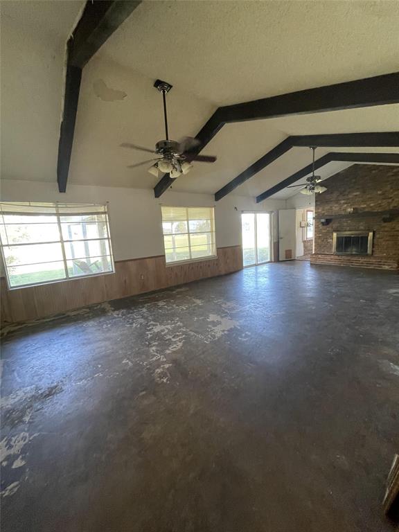 202 Spur Ranch Road Trinidad, TX 75163 - Photo 6 of 20 en empty room with windows and ceiling fan