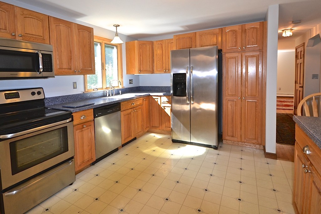 19 Bishop Road Rochester, MA 02770 - Photo 2 of 21 a kitchen with stainless steel appliances granite countertop a stove a sink and a microwave