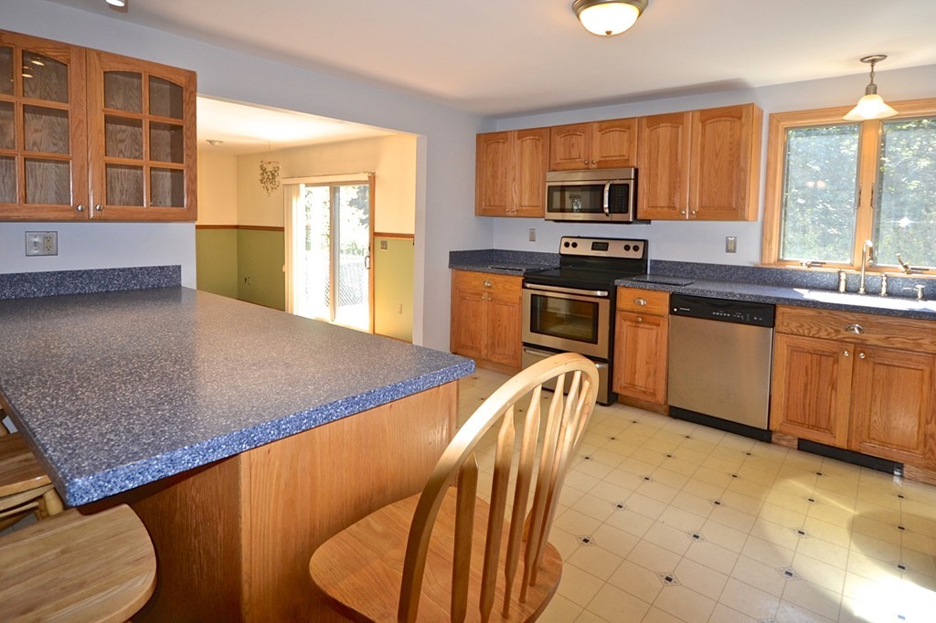 19 Bishop Road Rochester, MA 02770 - Photo 6 of 21 a kitchen with stainless steel appliances granite countertop a stove a sink a dining table and chairs