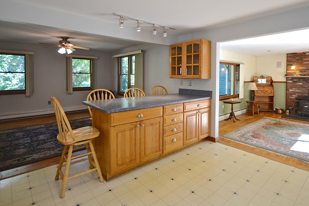 19 Bishop Road Rochester, MA 02770 - Photo 7 of 21 a kitchen with granite countertop a table chairs stove and cabinets