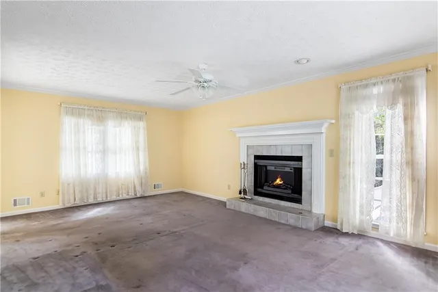 a view of a livingroom with a fireplace and window