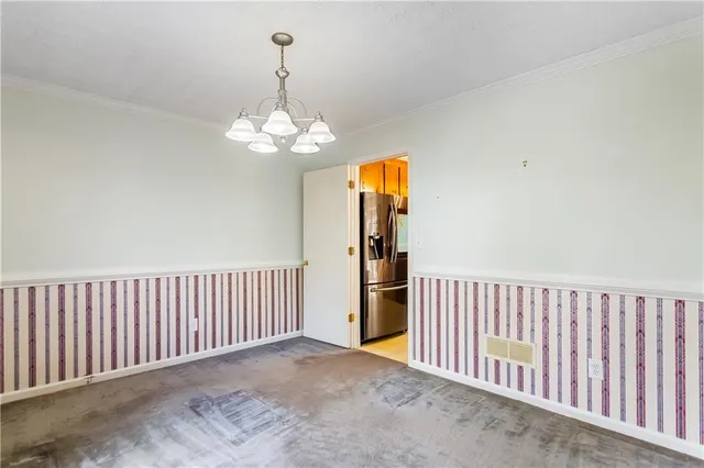 a view of a hallway with chandelier