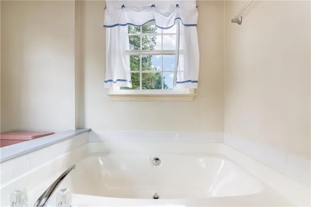 a bath tub sitting next to a window
