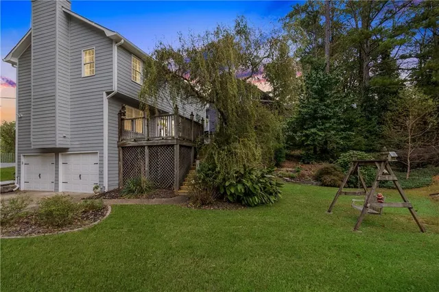 a view of backyard with a table and chairs and potted plants
